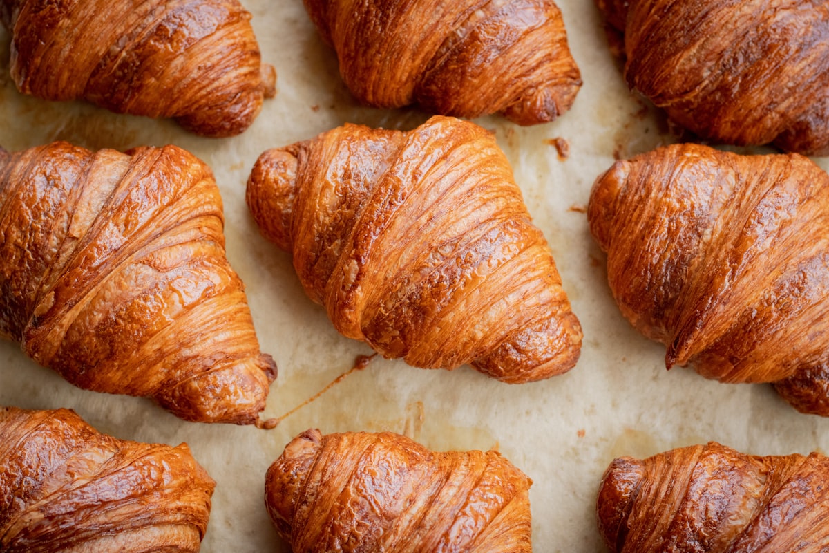 Baked croissants cooling on parchment